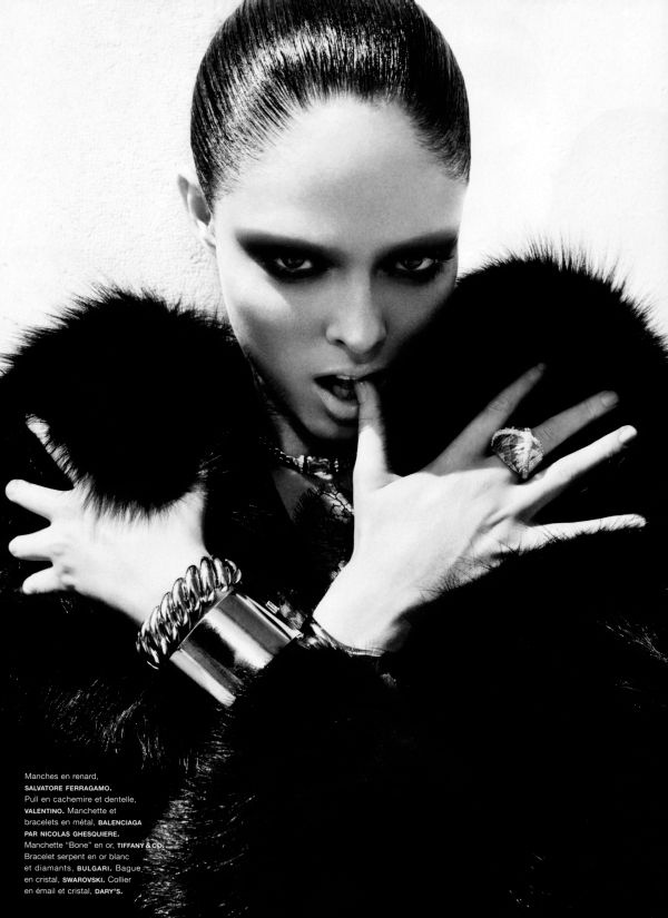 Model with a smoky black eye and bleached brows, arms crossed in black fur, in the Lace & Noir portrait
